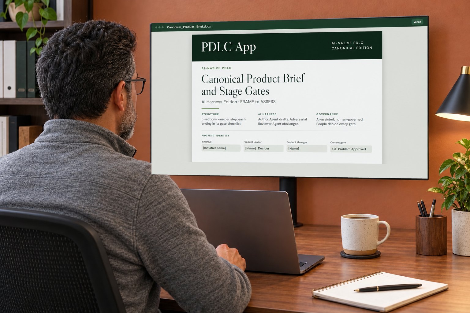 A product manager at his desk with the Canonical Product Brief template on a large monitor